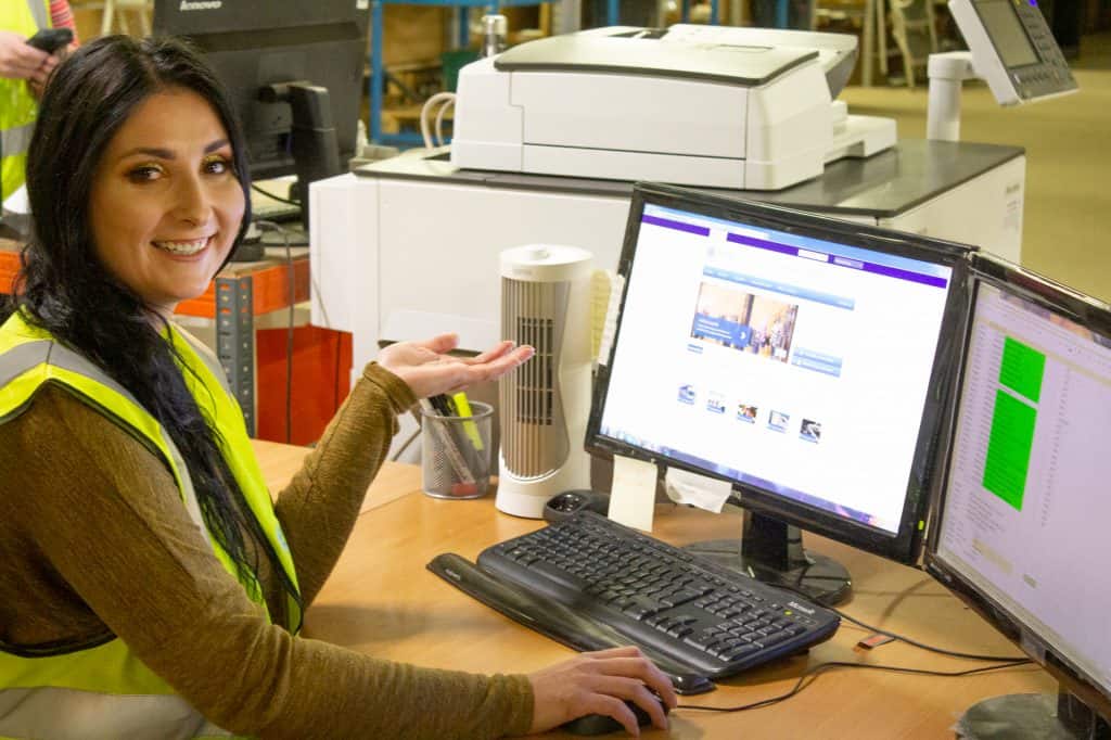 Warehouse employee showing warehouse management system